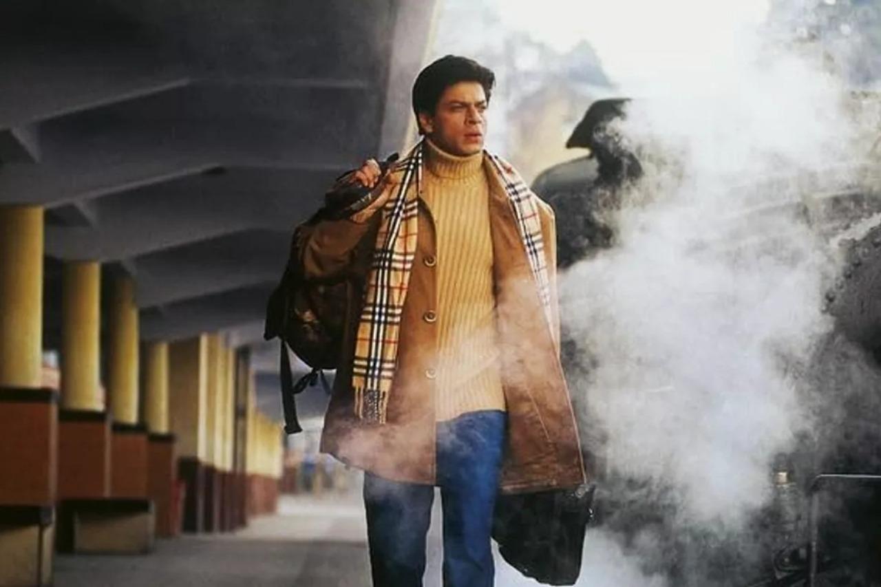 Main Hoon Na (2004)
Farah Khan’s stylish entertainer features Shah Rukh Khan as Major Ram Prasad Sharma, an army officer on a secret mission to protect his general’s daughter while reuniting with his estranged family. Posing as a college student, Ram balances duty, emotion, and comedy with trademark SRK charisma. The film blends patriotism, family drama, and nostalgia seamlessly